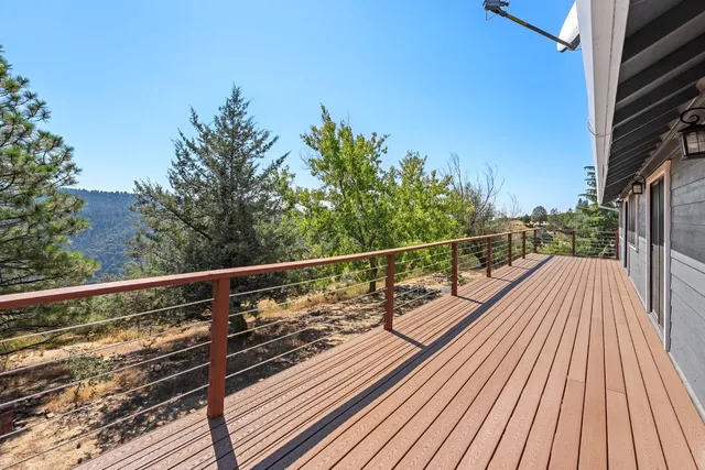 a view of balcony with wooden floor and fence