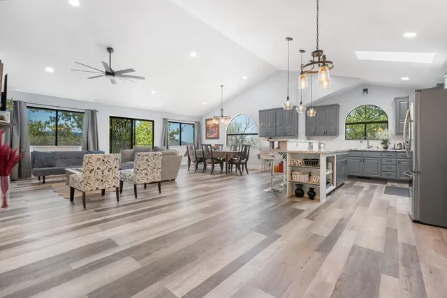 a living room with lots of furniture and a chandelier