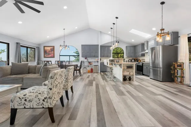 a living room with furniture and kitchen view
