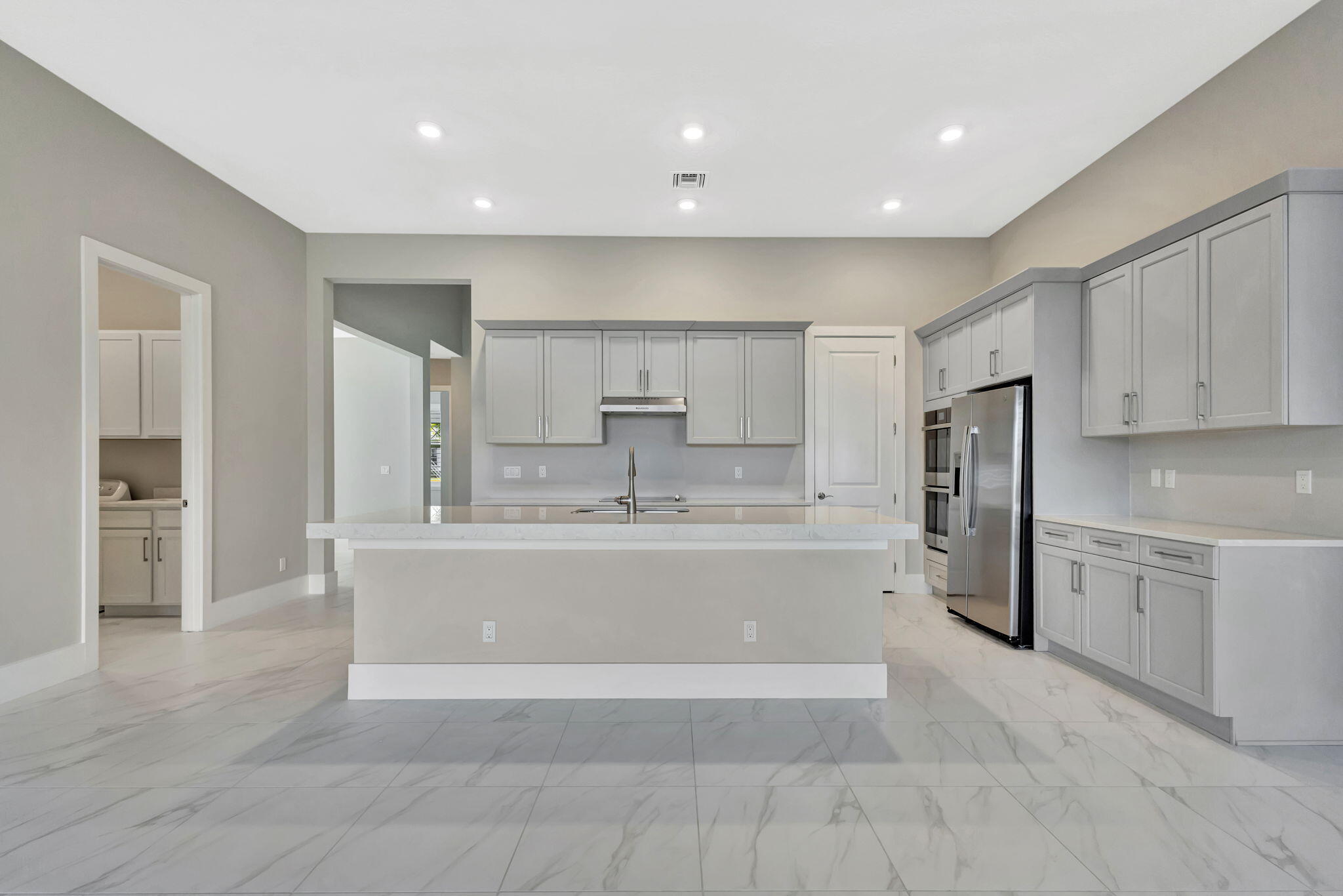 11953 Southwest Vano Way Port Port St. Lucie, FL 34987 - Photo 11 of 74 a view of kitchen with center island and stainless steel appliances