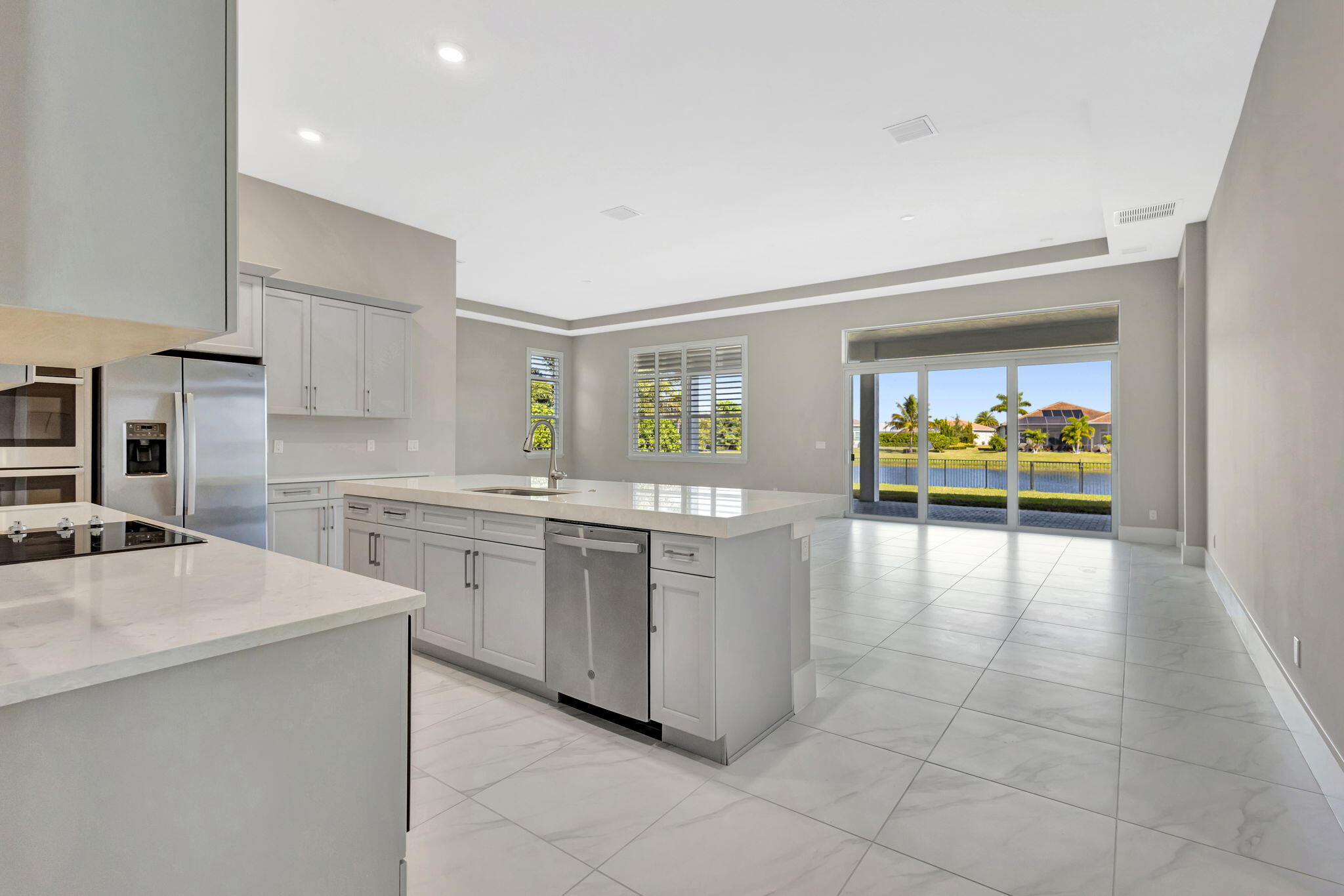 11953 Southwest Vano Way Port Port St. Lucie, FL 34987 - Photo 20 of 74 a kitchen with stainless steel appliances a stove a sink and a refrigerator