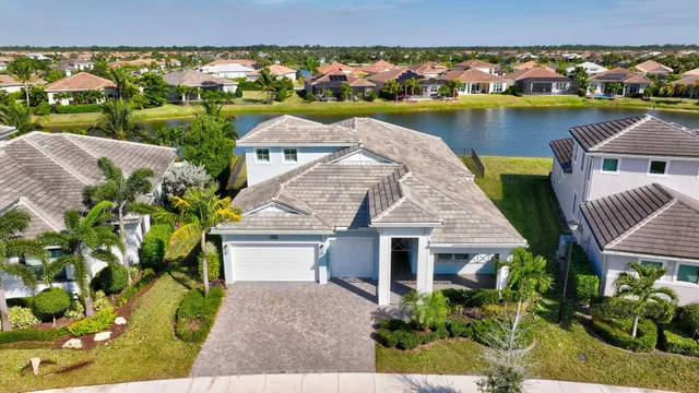 an aerial view of a house with a garden and lake view