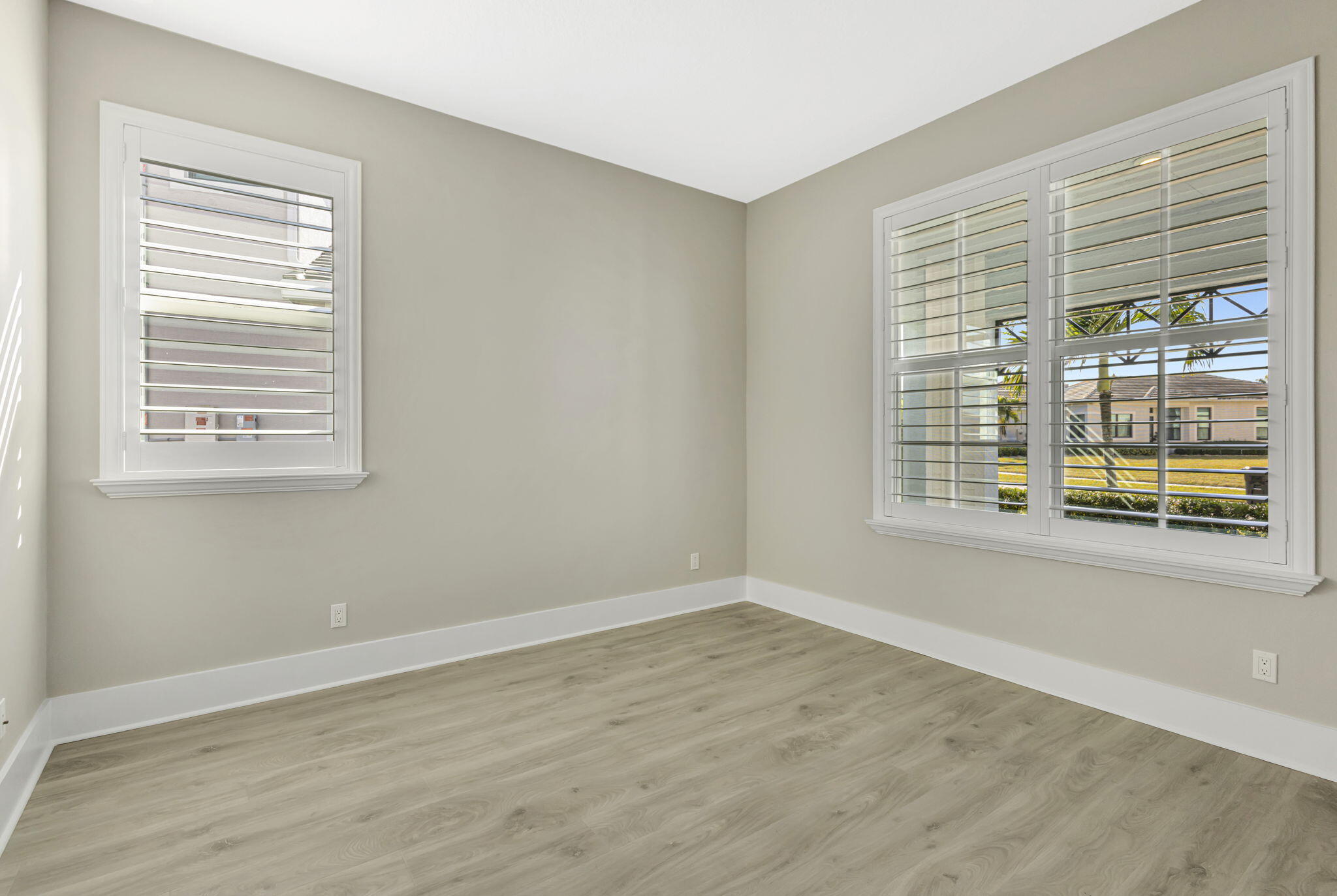 11953 Southwest Vano Way Port Port St. Lucie, FL 34987 - Photo 23 of 74 a view of an empty room with wooden floor and a window