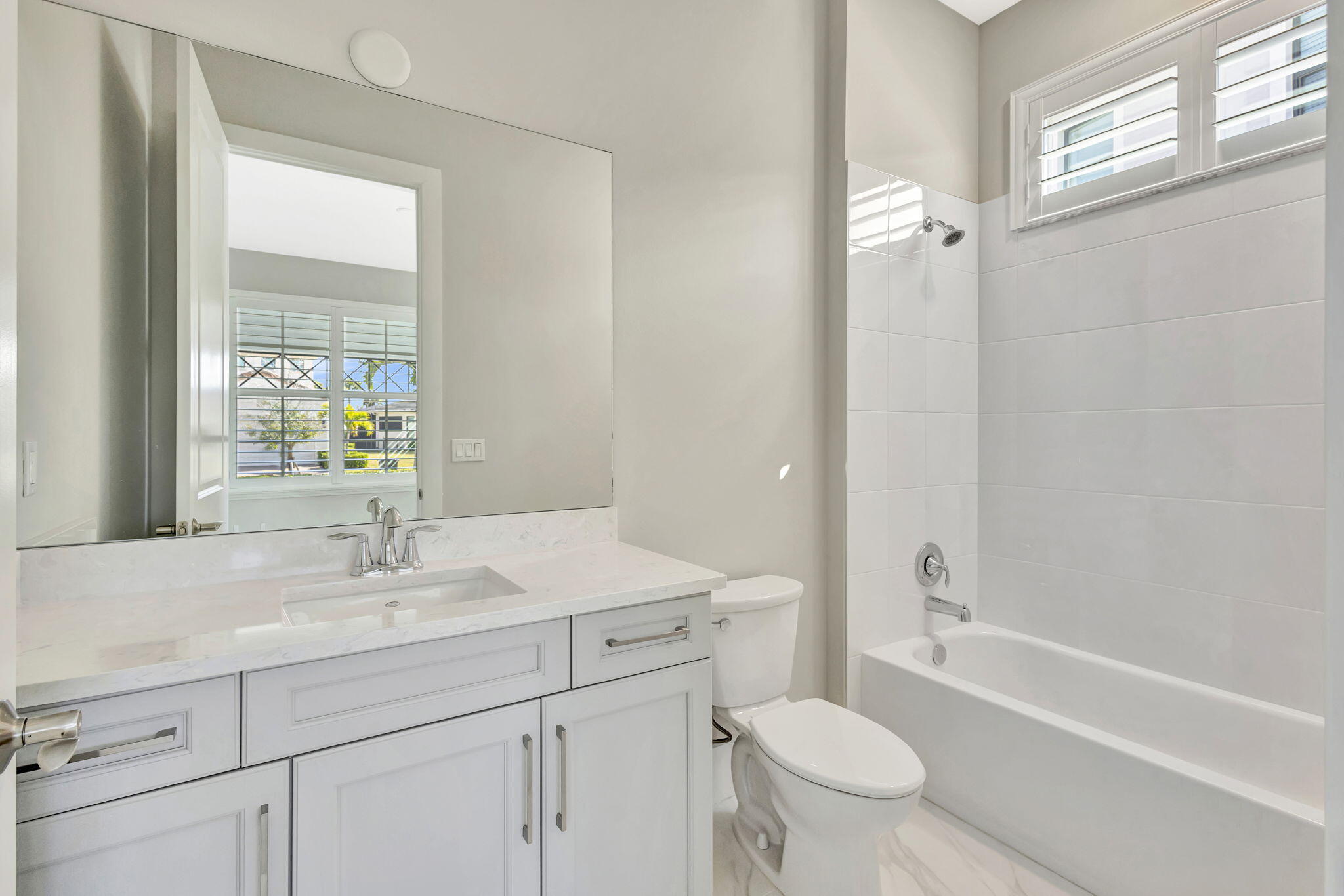 11953 Southwest Vano Way Port Port St. Lucie, FL 34987 - Photo 25 of 74 a bathroom with a sink a toilet and a bathtub