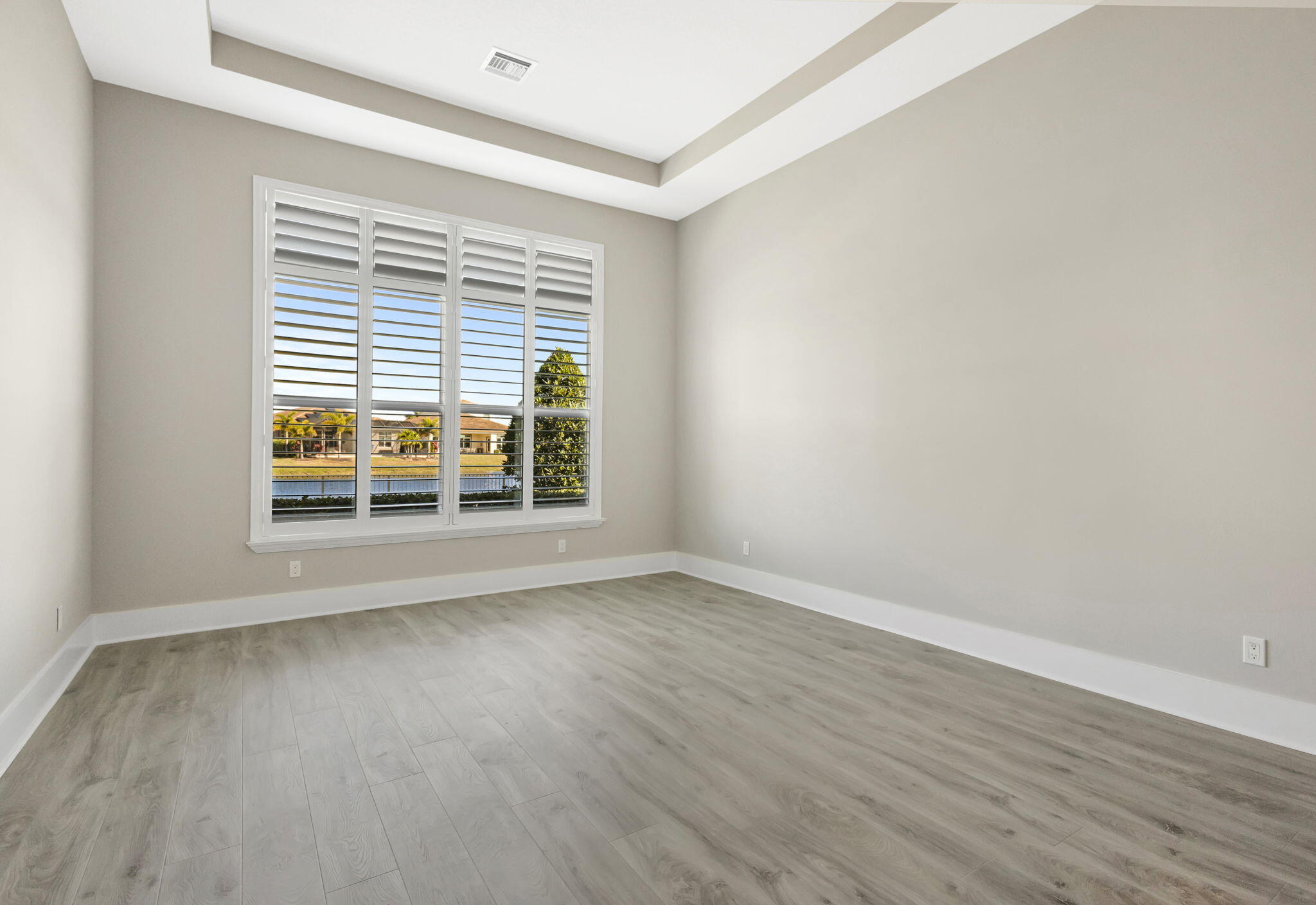 11953 Southwest Vano Way Port Port St. Lucie, FL 34987 - Photo 33 of 74 an empty room with wooden floor and windows