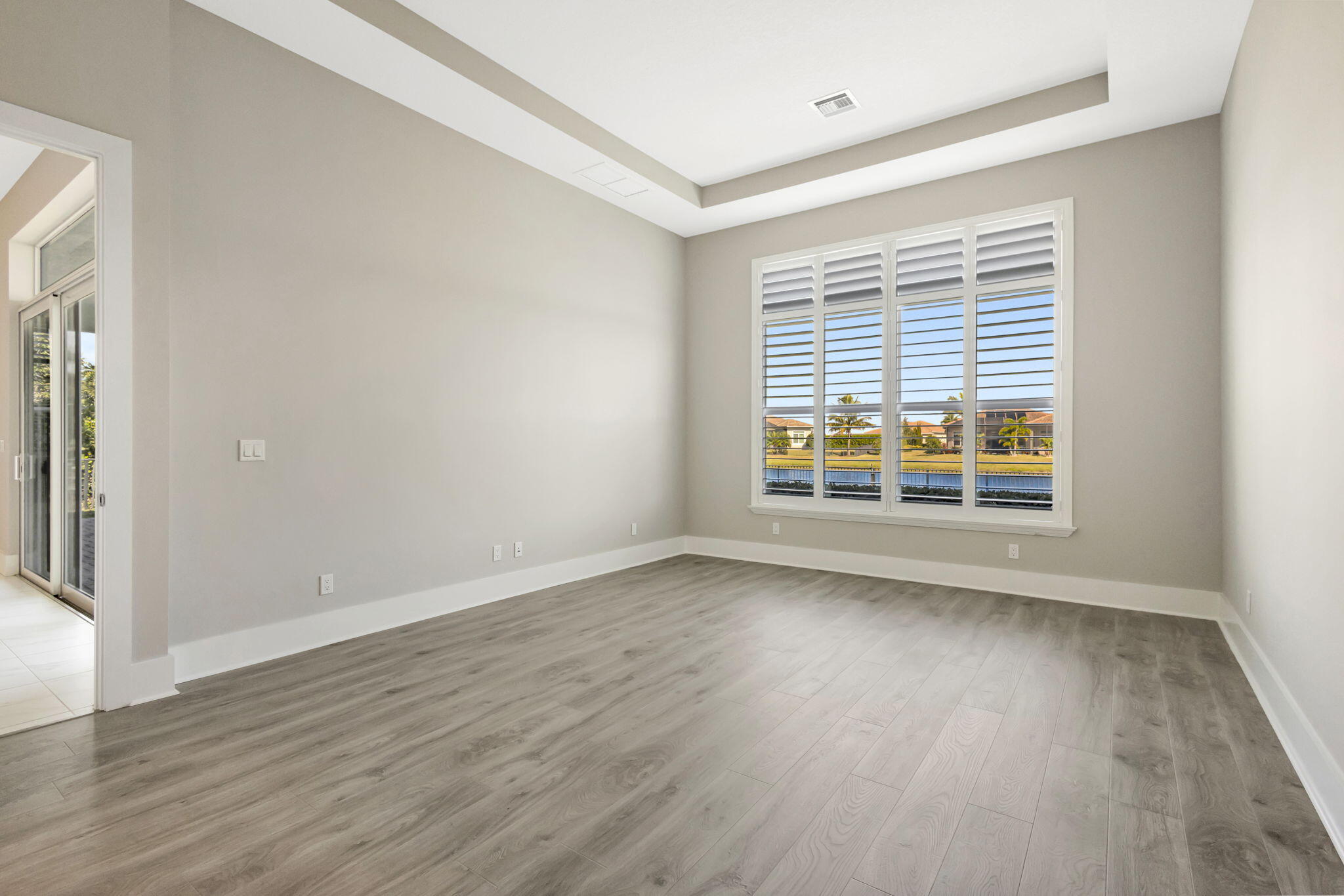 11953 Southwest Vano Way Port Port St. Lucie, FL 34987 - Photo 34 of 74 a view of an empty room with wooden floor and a window