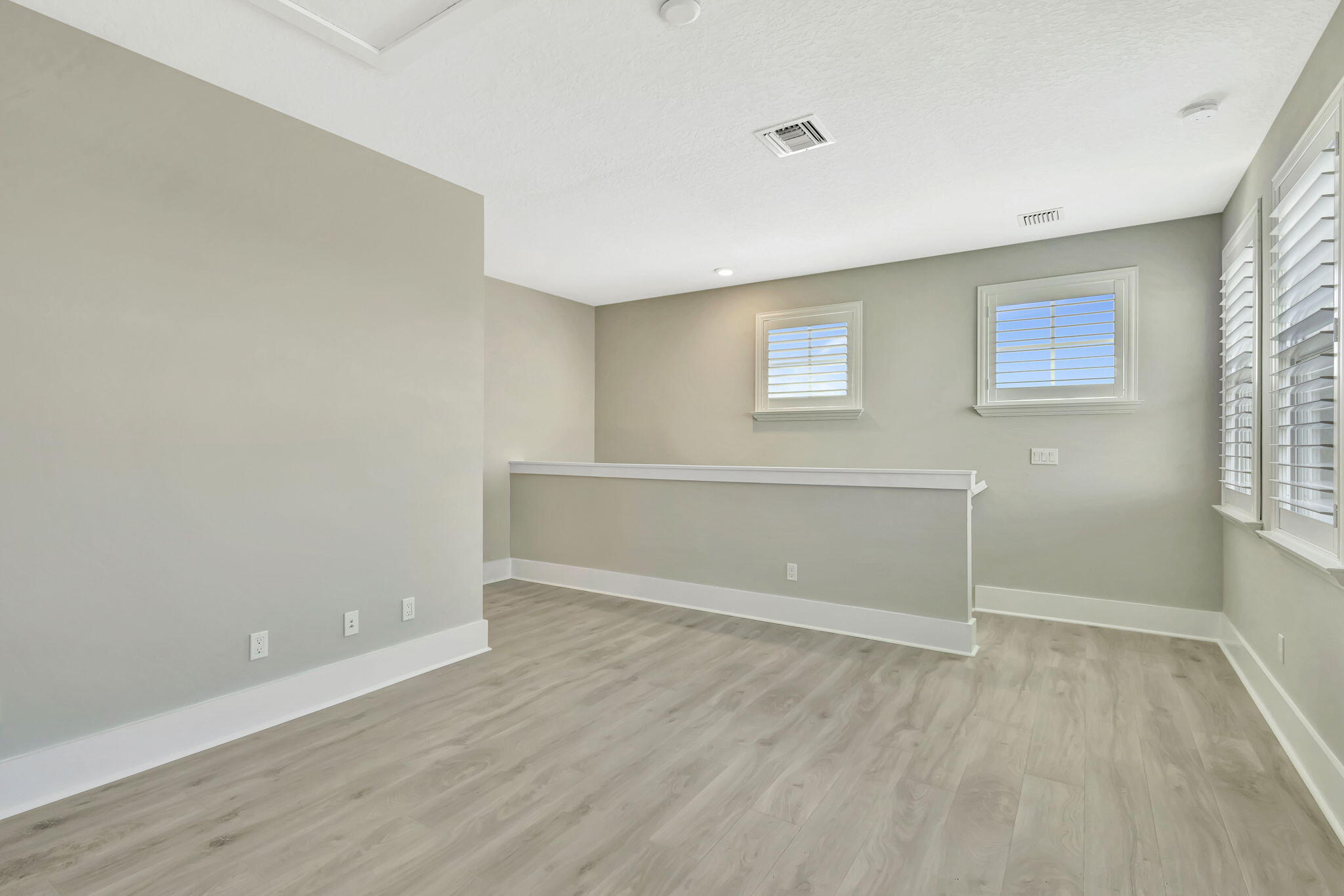 11953 Southwest Vano Way Port Port St. Lucie, FL 34987 - Photo 38 of 74 a view of an empty room with wooden floor and a window