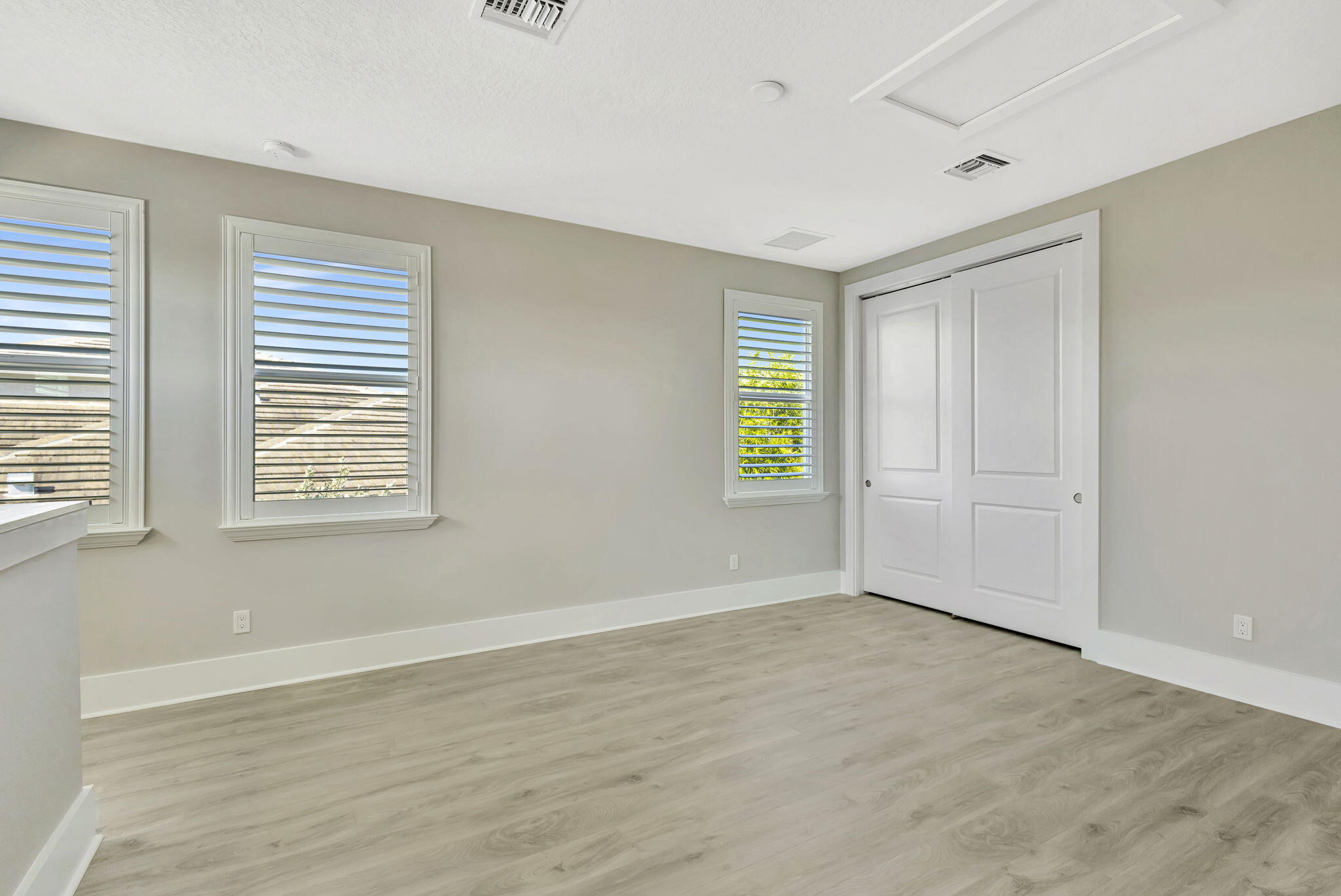 11953 Southwest Vano Way Port Port St. Lucie, FL 34987 - Photo 39 of 74 a view of an empty room with wooden floor and a window