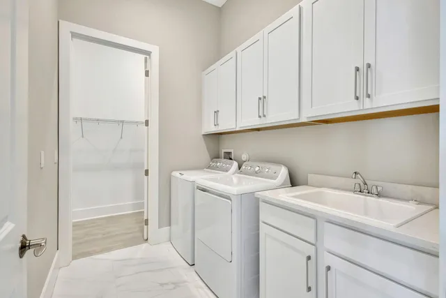 an aerial view of residential houses with outdoor space and lake view