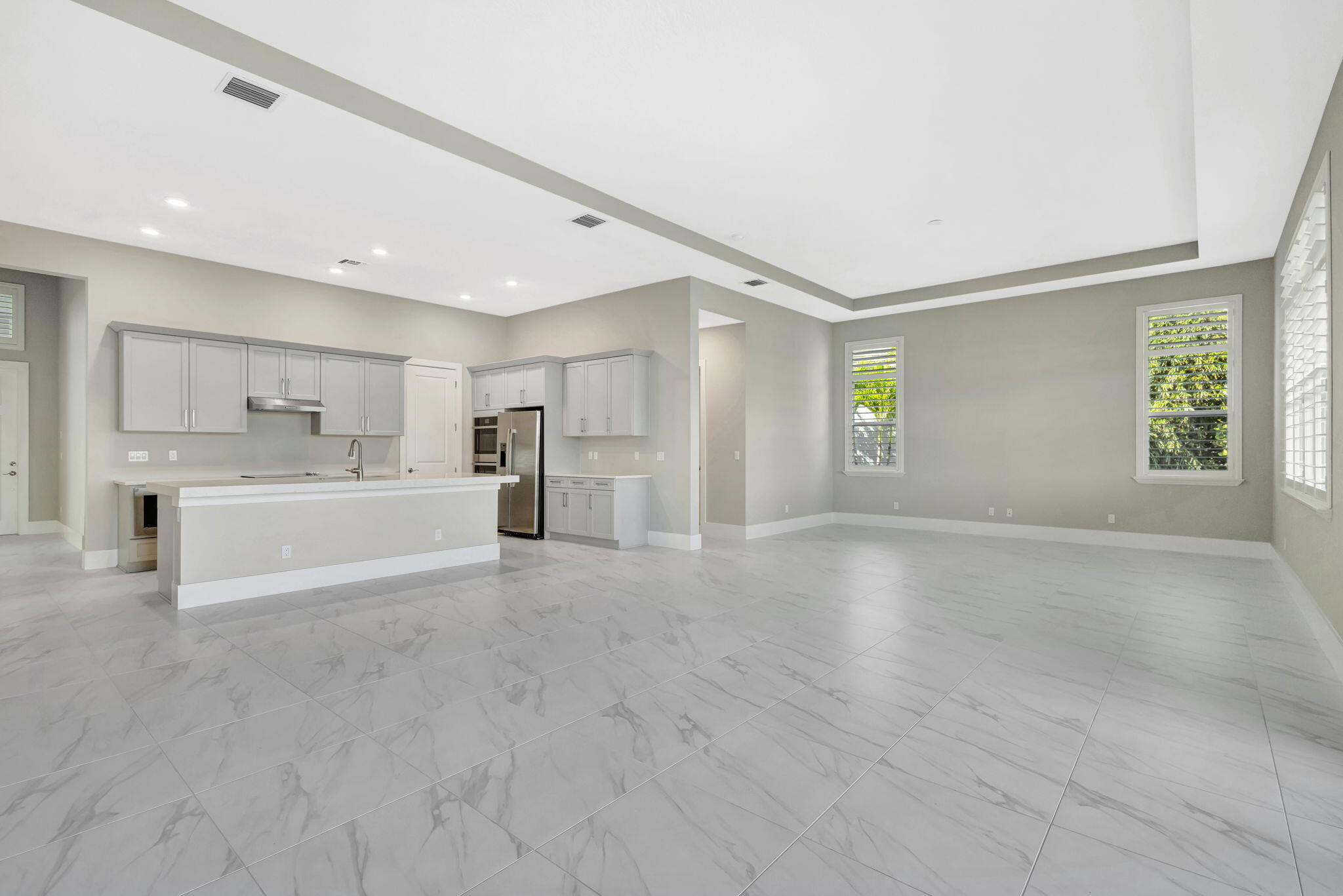 11953 Southwest Vano Way Port Port St. Lucie, FL 34987 - Photo 47 of 74 a view of a kitchen with a sink and a refrigerator