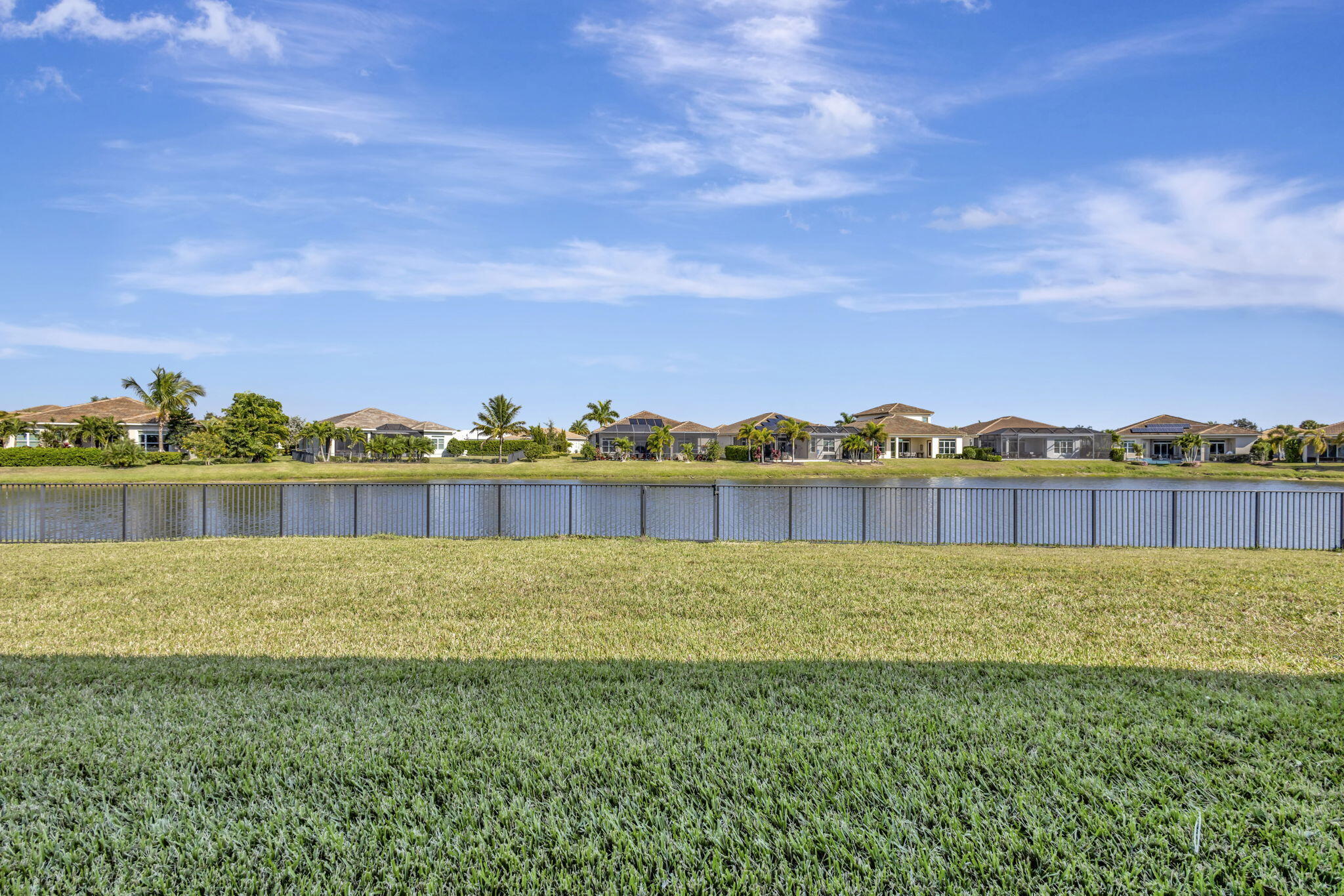 11953 Southwest Vano Way Port Port St. Lucie, FL 34987 - Photo 56 of 74 a view of a lake with houses in the back