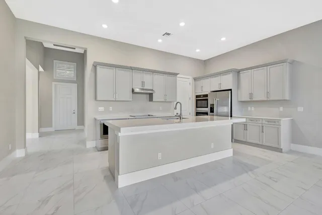 a kitchen with cabinets and stainless steel appliances