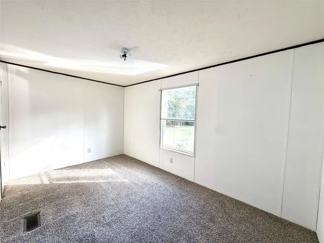 an empty room with a empty space and windows