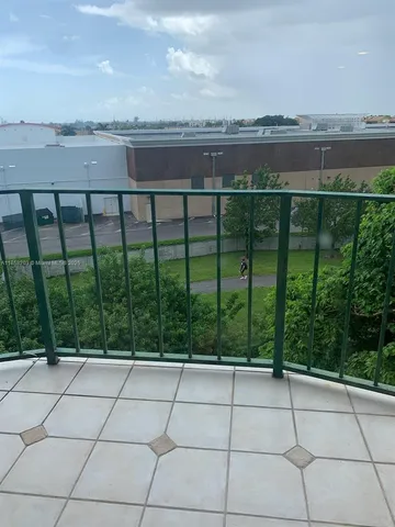 a swimming pool with outdoor seating and trees