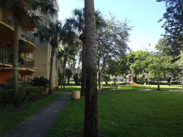 a view of a park with large trees