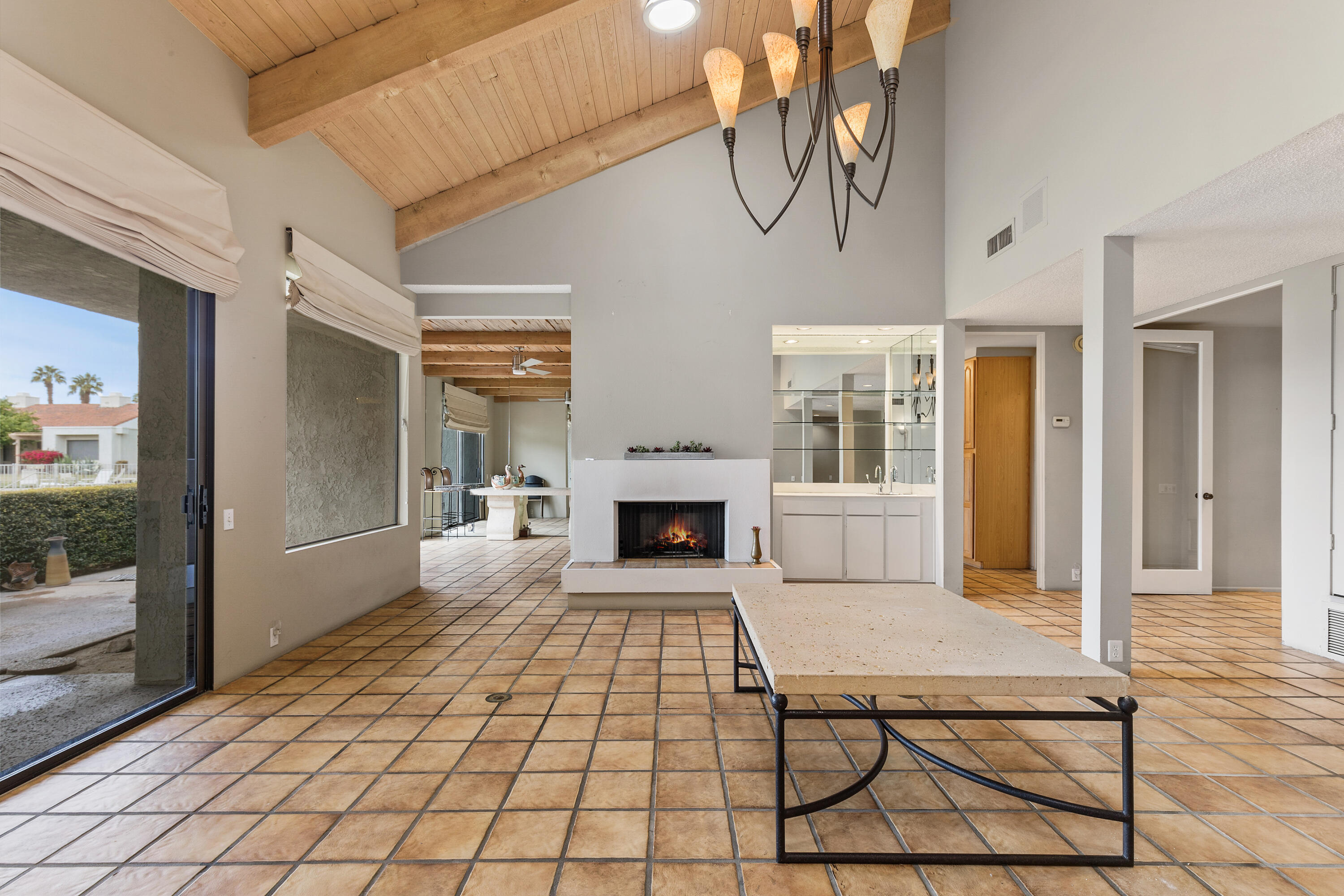 722 Inverness Drive Rancho Mirage, CA 92270 - Photo 14 of 59 a living room with a table chairs and a fireplace