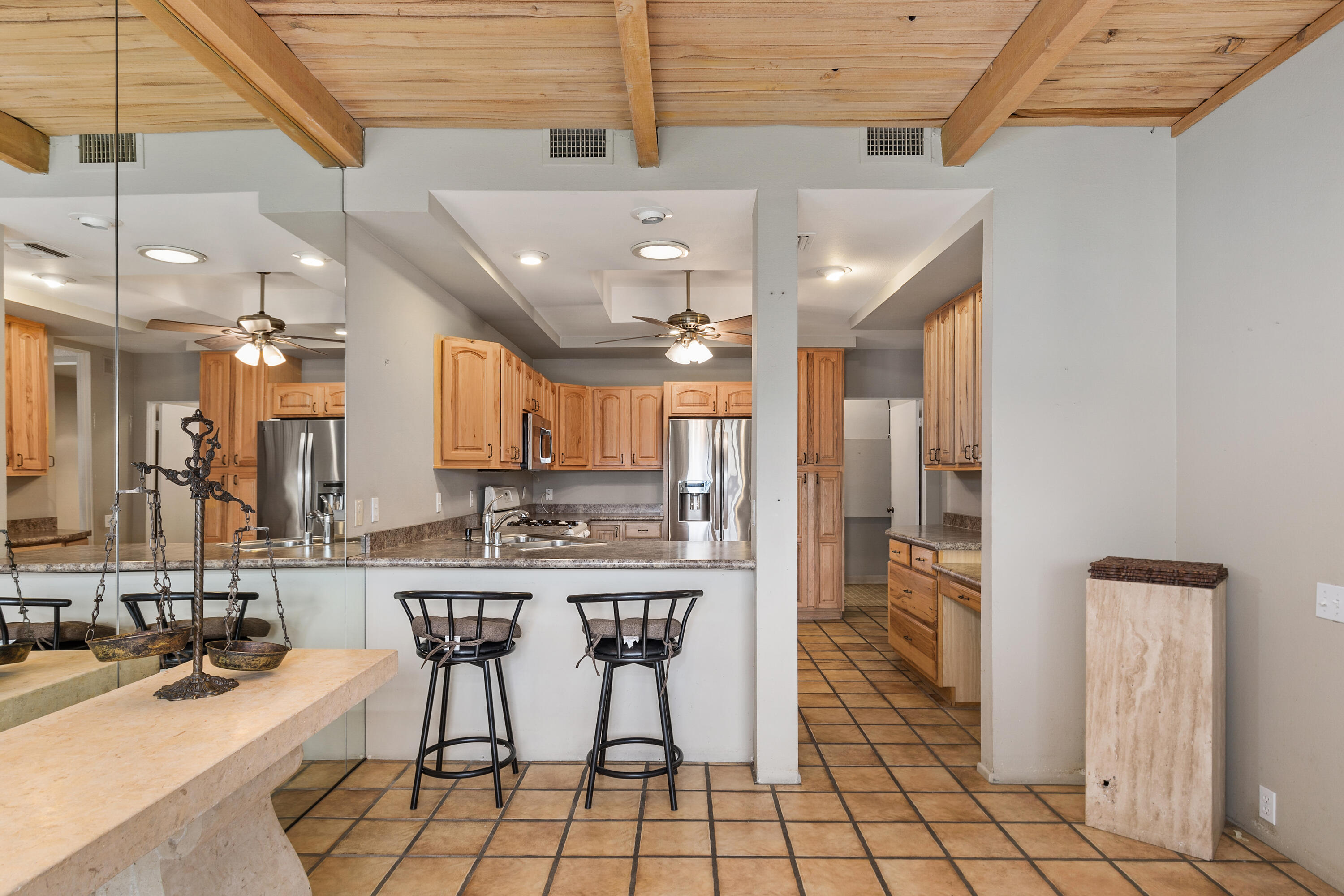 722 Inverness Drive Rancho Mirage, CA 92270 - Photo 15 of 59 a kitchen with stainless steel appliances kitchen island granite countertop a sink and cabinets