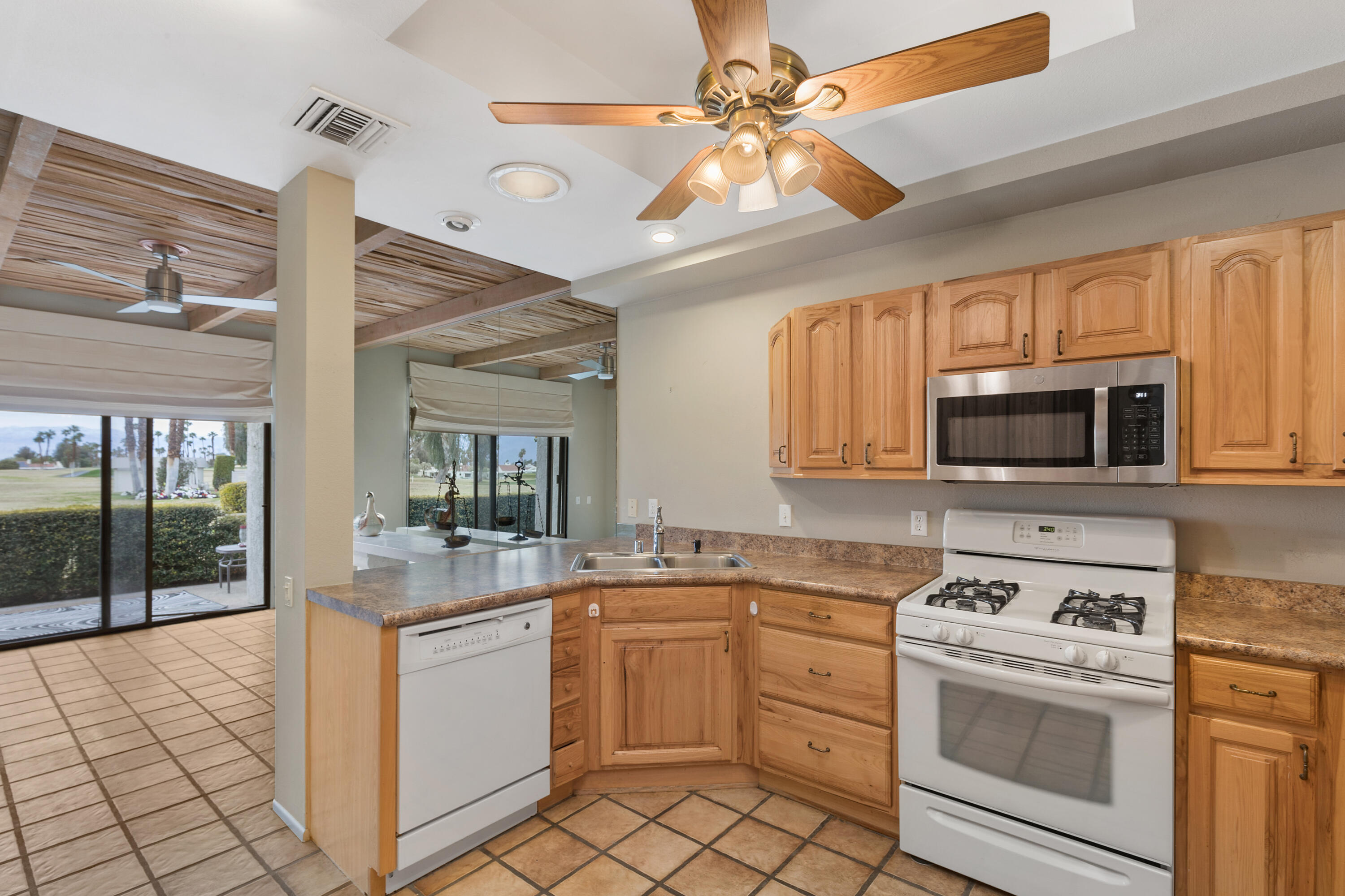 722 Inverness Drive Rancho Mirage, CA 92270 - Photo 16 of 59 a kitchen with a stove sink and a microwave