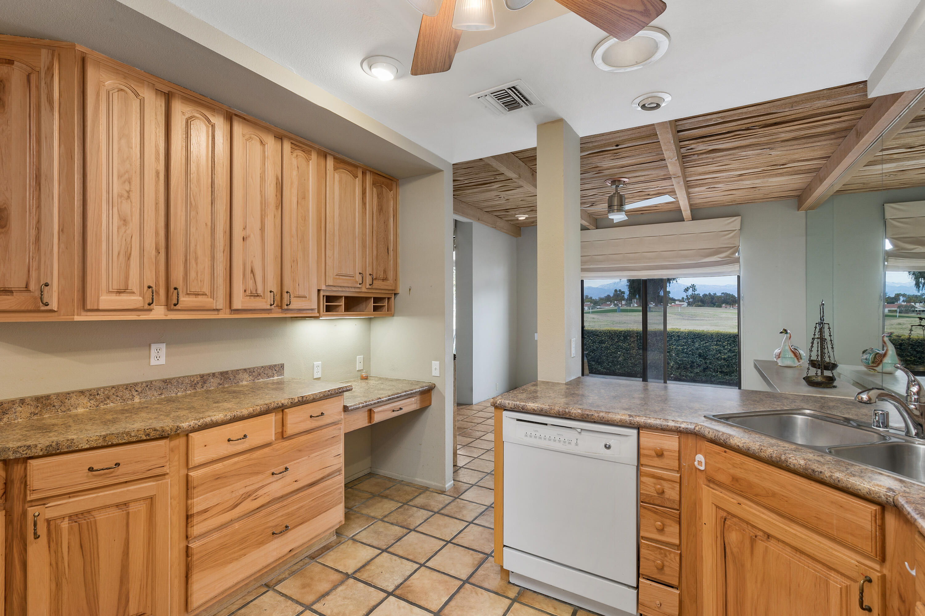 722 Inverness Drive Rancho Mirage, CA 92270 - Photo 17 of 59 a kitchen with granite countertop cabinets stainless steel appliances a sink and a large window