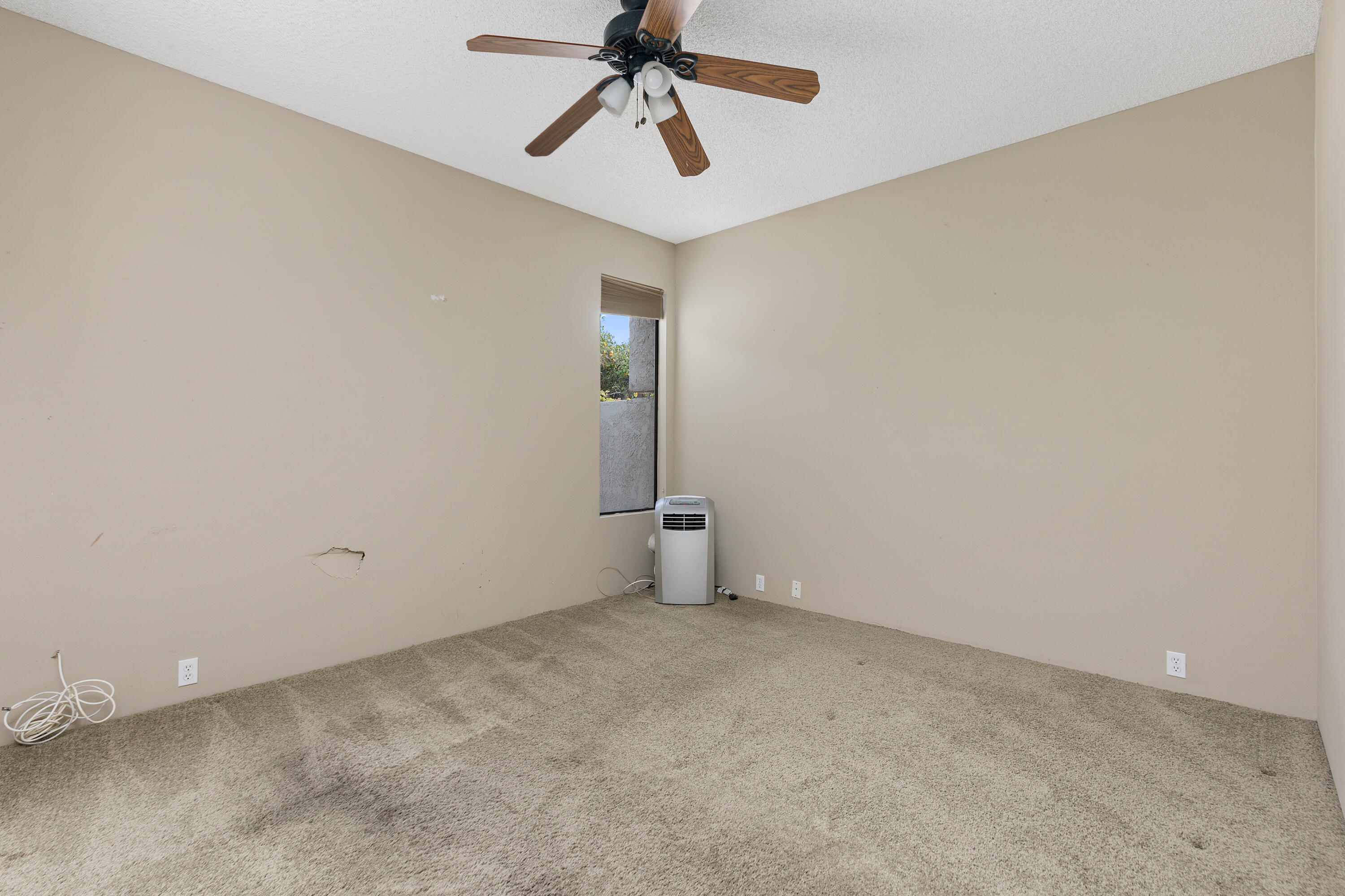 722 Inverness Drive Rancho Mirage, CA 92270 - Photo 22 of 59 an empty room with chandelier fan