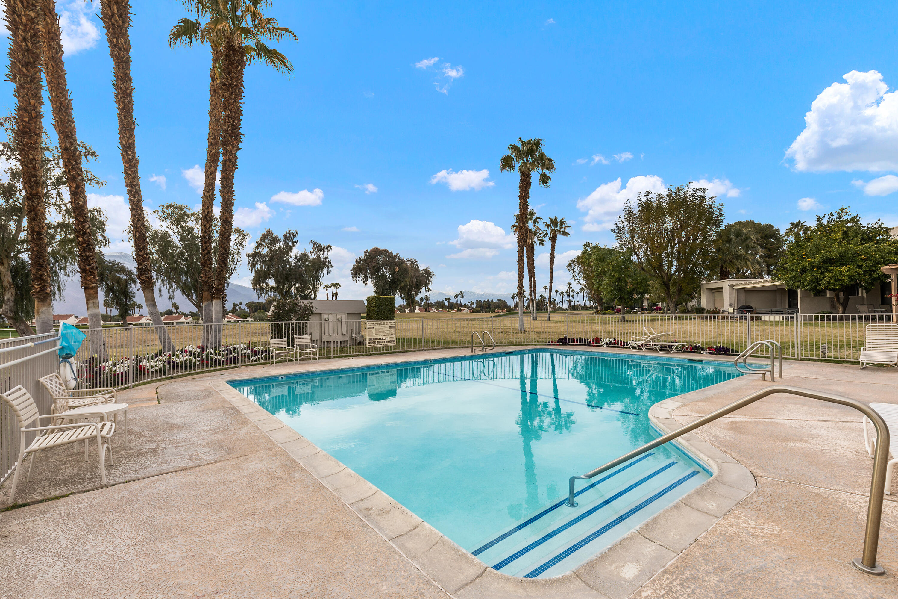 722 Inverness Drive Rancho Mirage, CA 92270 - Photo 32 of 59 a view of a swimming pool with a patio and a garden