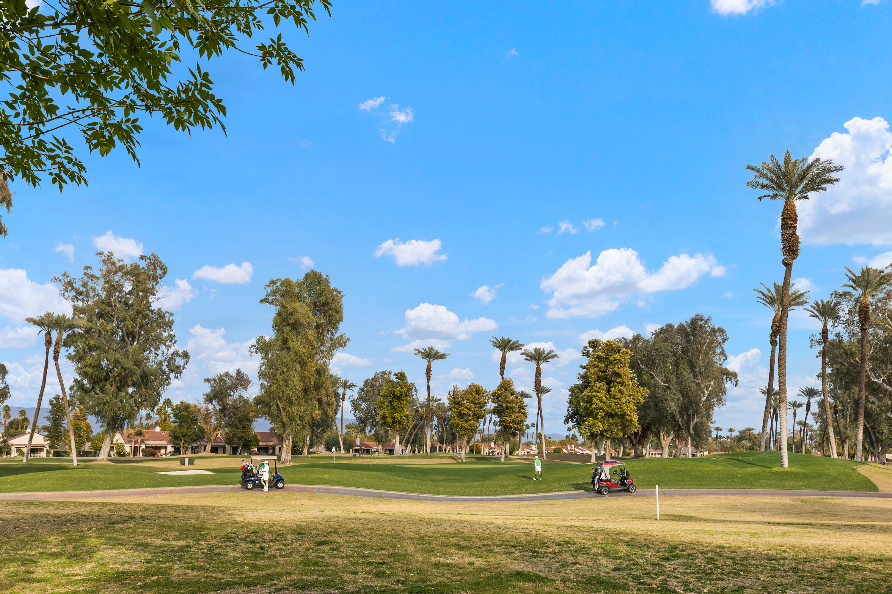 722 Inverness Drive Rancho Mirage, CA 92270 - Photo 35 of 59 a view of a fountain in front of a house with a big yard