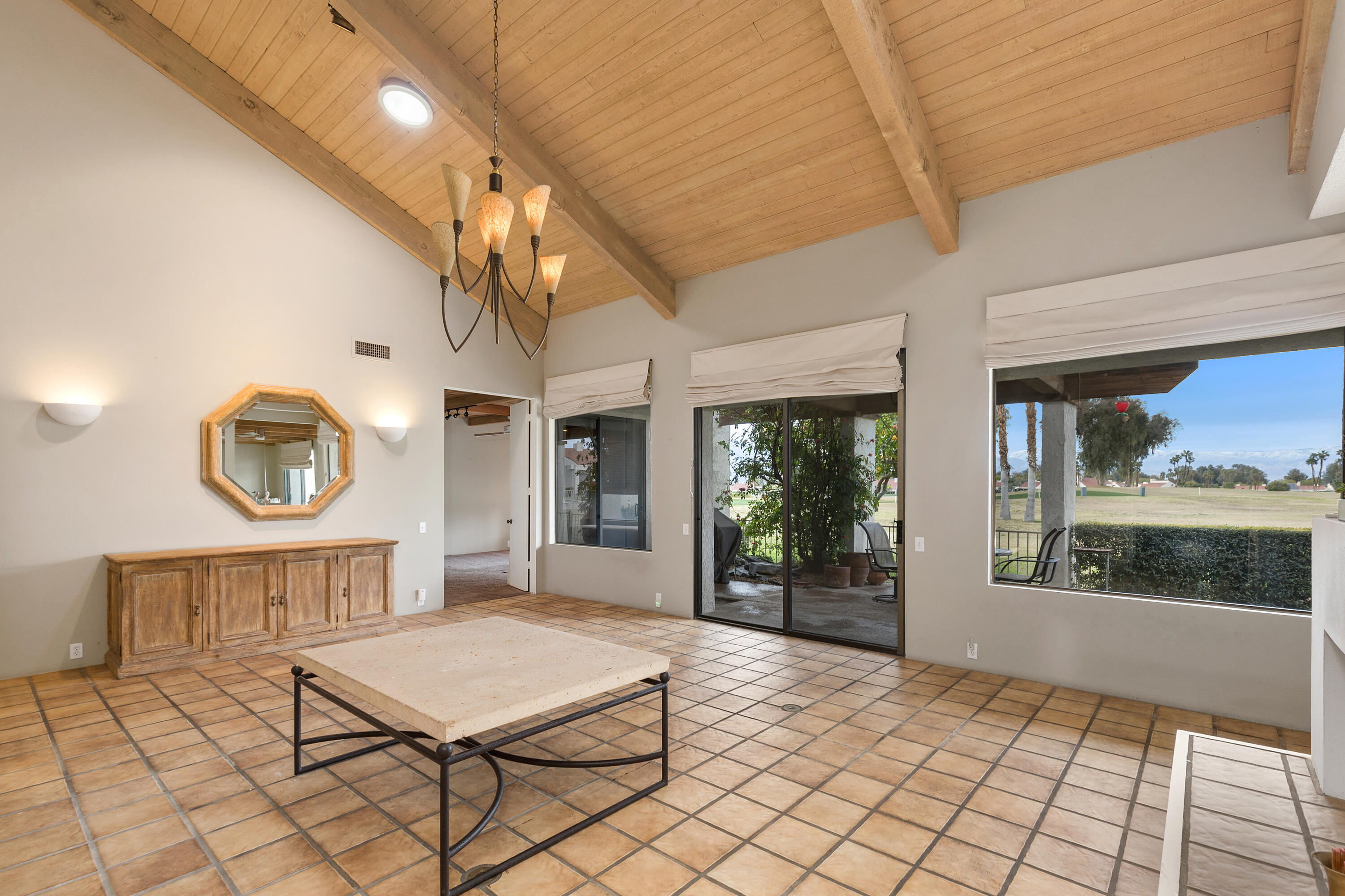 722 Inverness Drive Rancho Mirage, CA 92270 - Photo 4 of 59 a living room with a table and a large window
