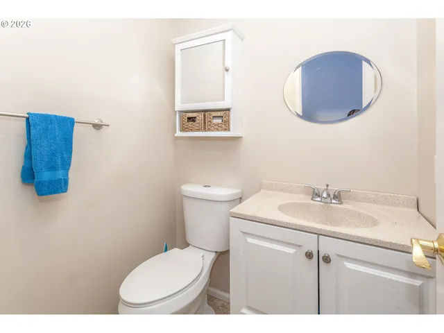 a bathroom with a toilet a sink and mirror