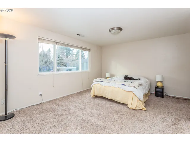 a bedroom with a bed and a window