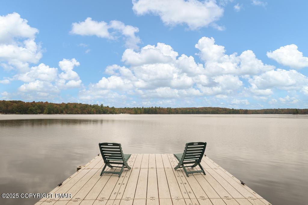 106 Waygood Way Pocono Pines, PA 18350 - Photo 1 of 66 a wooden bench sitting on top of a lake