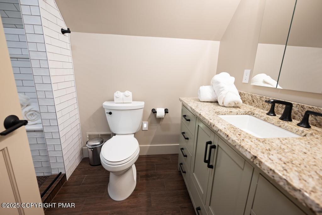 106 Waygood Way Pocono Pines, PA 18350 - Photo 25 of 66 a bathroom with a granite countertop toilet sink and mirror