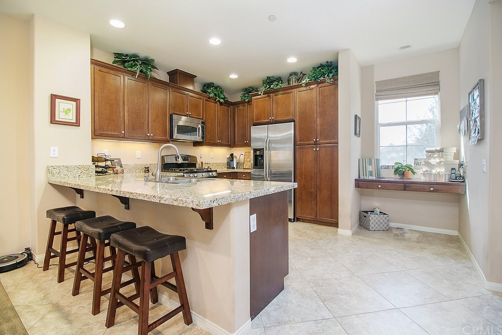 15205 Fairfax Way Tustin, CA 92782 - Photo 11 of 28 a kitchen with stainless steel appliances granite countertop a refrigerator and a stove top oven