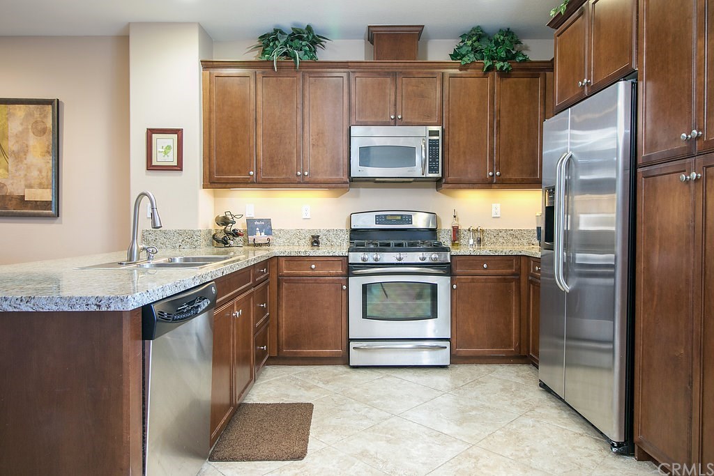 15205 Fairfax Way Tustin, CA 92782 - Photo 12 of 28 a kitchen with a sink stove and refrigerator