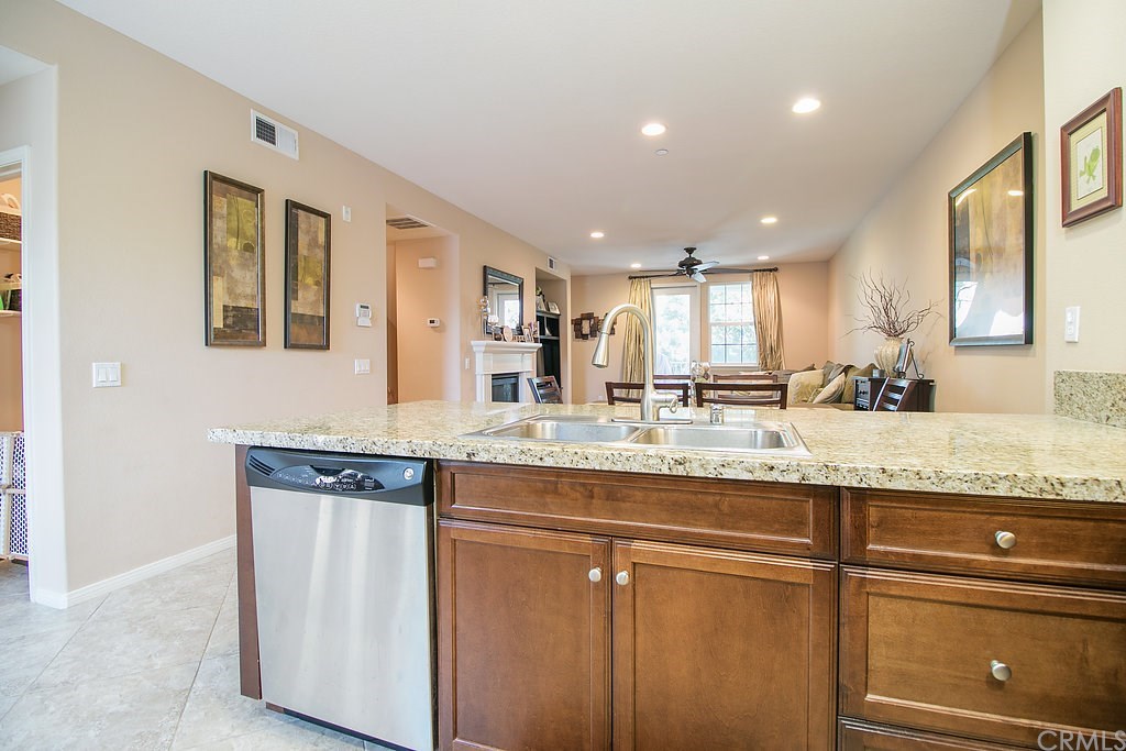 15205 Fairfax Way Tustin, CA 92782 - Photo 13 of 28 a kitchen with granite countertop kitchen island with stainless steel appliances granite countertop cabinets and a sink