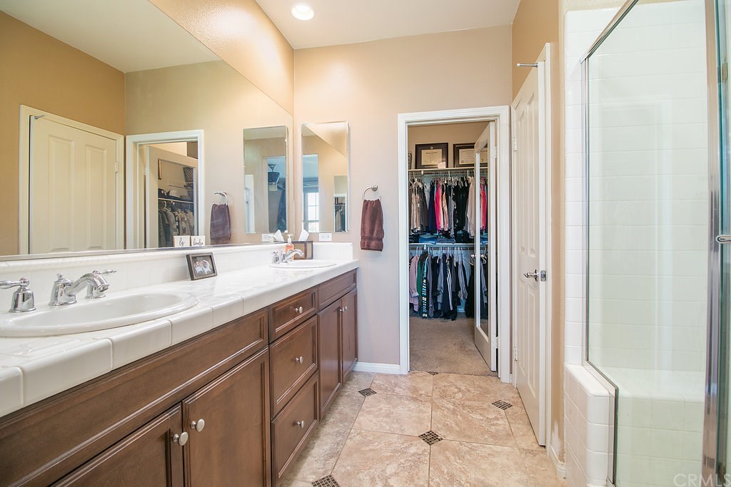 15205 Fairfax Way Tustin, CA 92782 - Photo 18 of 28 a en suite bathroom with a double vanity sink and a mirror