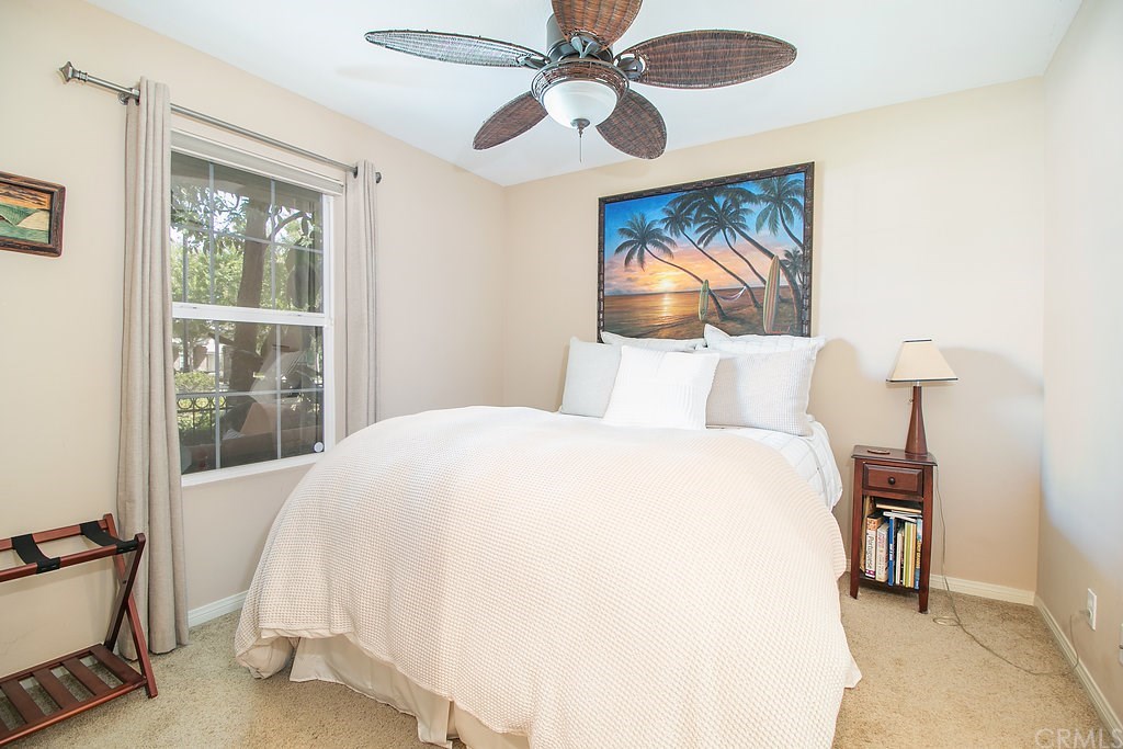 15205 Fairfax Way Tustin, CA 92782 - Photo 5 of 28 a bedroom with a bed and a chandelier