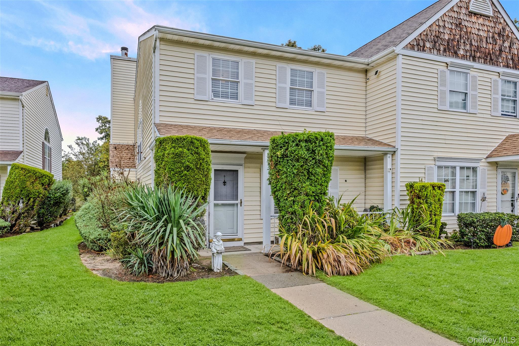 a front view of a house with a garden