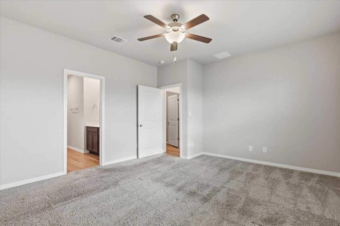 17705 Prairie Land Way Manor, TX 78653 - Photo 10 of 29 a view of an empty room with a ceiling fan