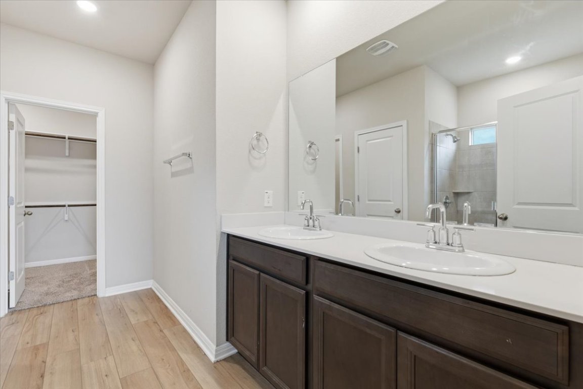 17705 Prairie Land Way Manor, TX 78653 - Photo 11 of 29 a bathroom with a double vanity sink a and mirror