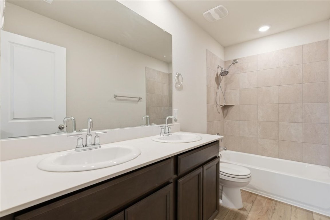 17705 Prairie Land Way Manor, TX 78653 - Photo 19 of 29 a bathroom with a sink a toilet a shower and a mirror