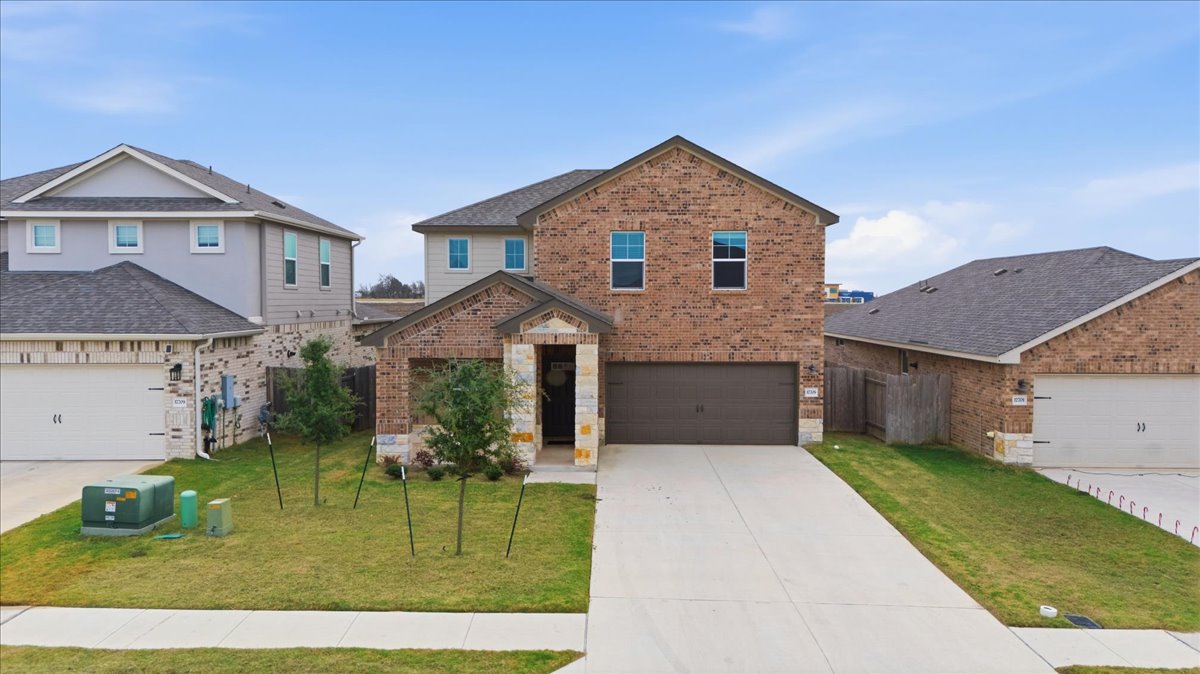 17705 Prairie Land Way Manor, TX 78653 - Photo 2 of 29 a front view of a house with a yard