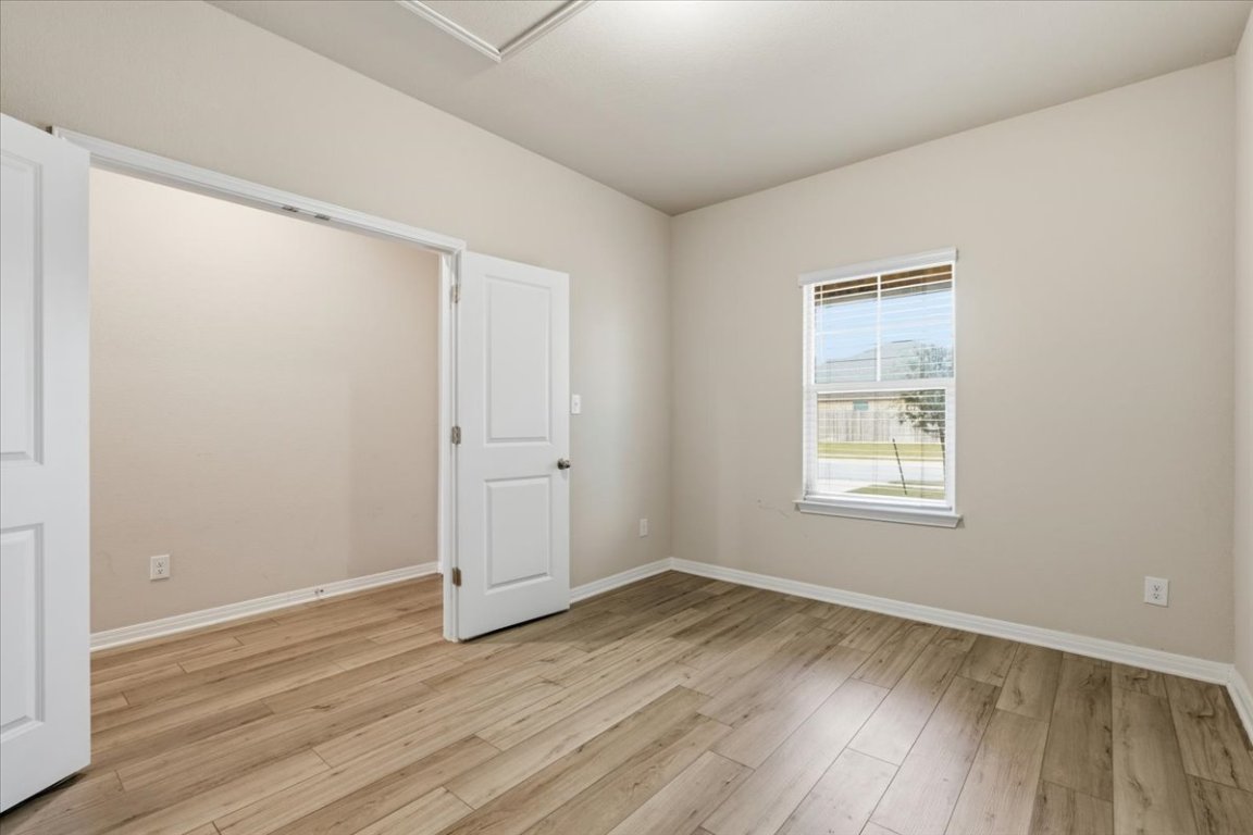 17705 Prairie Land Way Manor, TX 78653 - Photo 5 of 29 an empty room with wooden floor and windows