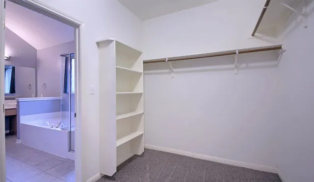 a view of walk in closet and bedroom view