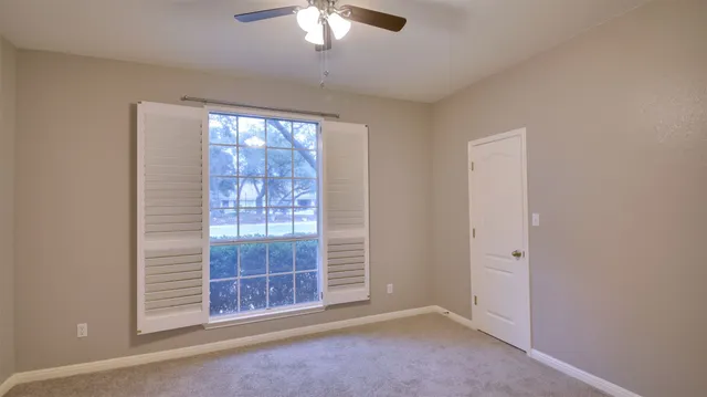 an empty room with windows curtains