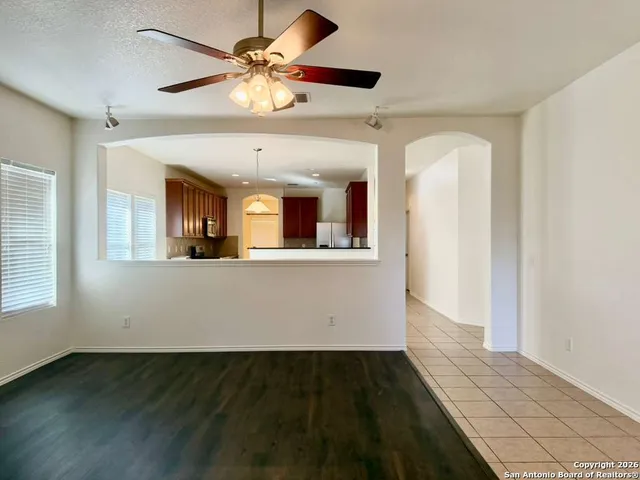 a view of a kitchen with an empty space and a window