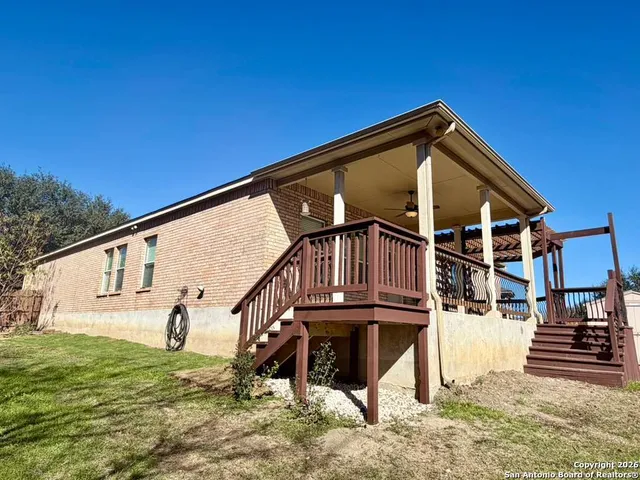 a backyard of a house with wooden fence