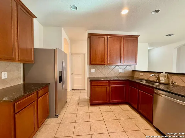 a view of a kitchen with a sink and a window