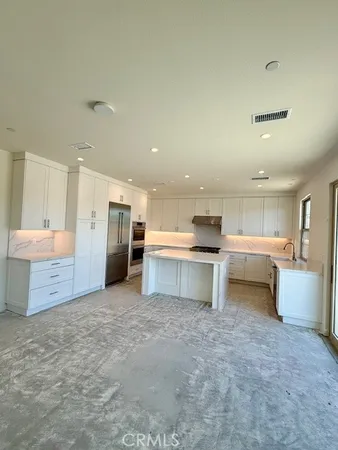 a view of a kitchen with a sink and cabinets