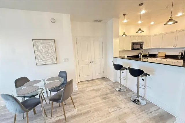 a kitchen with stainless steel appliances kitchen island granite countertop a stove a sink and a refrigerator