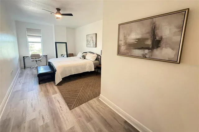 a bedroom with a bed and a painting on the wall